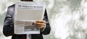 man reading newspaper about economy