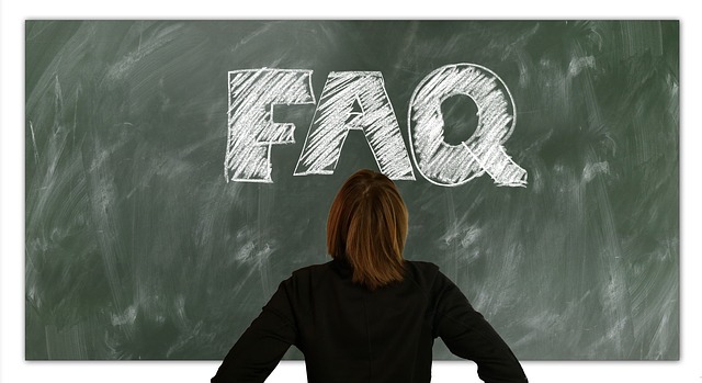 woman looking at chalk board written faq