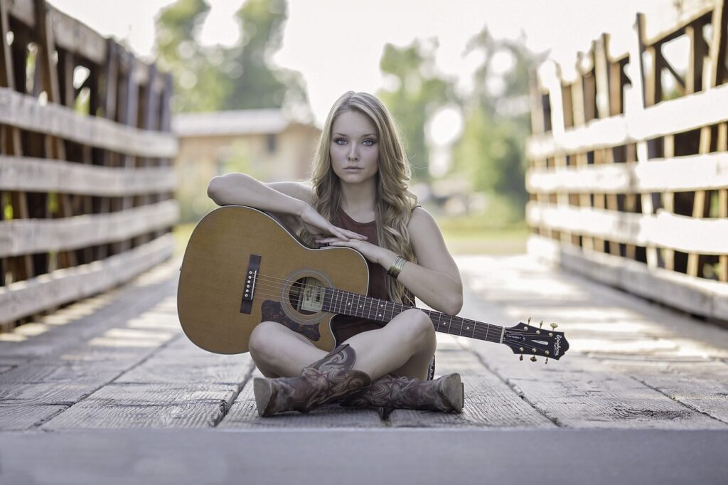 picture of girl sitting with her guitar