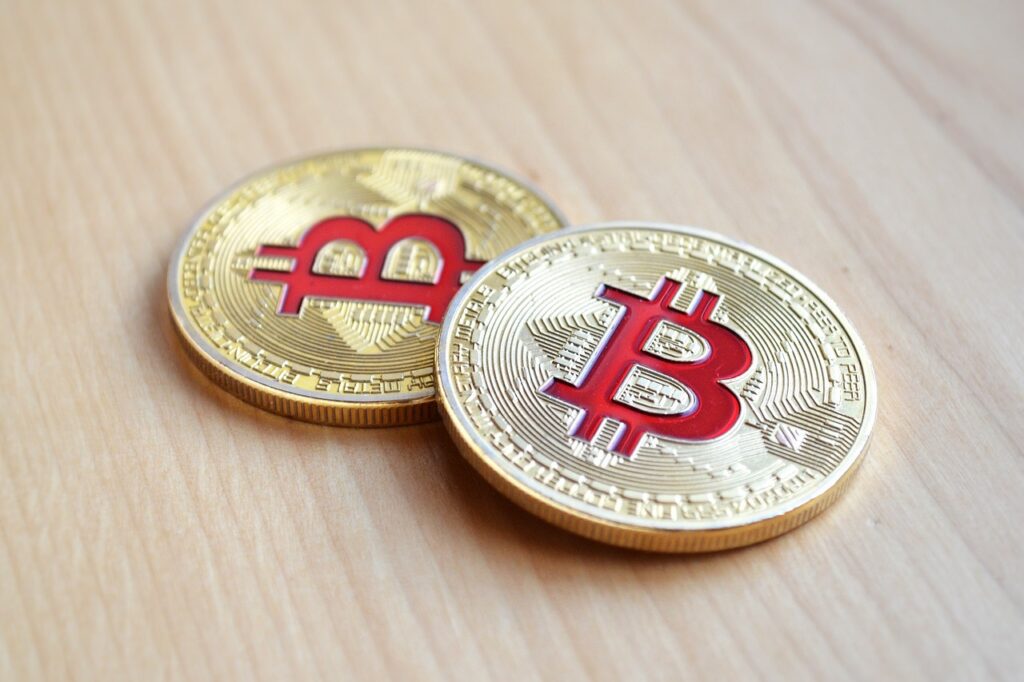 picture of gold coins with bitcoin logos