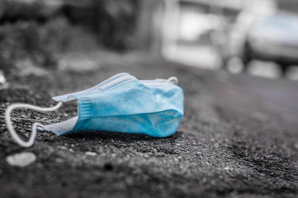 drab grey picture of mask on ground